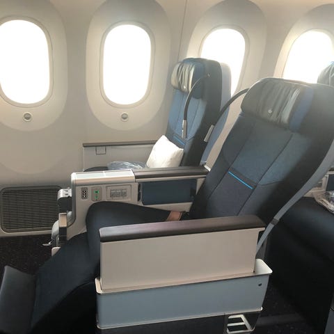 A KLM Premium Comfort seat reclined with the leg a