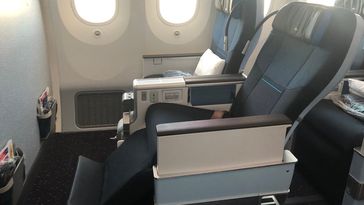 A KLM Premium Comfort seat reclined with the leg and foot rests extended