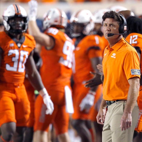Mike Gundy watches from the sidelines during a 58-