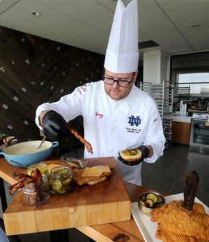 Travis Johnson, senior executive chef, builds a pork tenderloin sandwich similar to the ones offered at Notre Dame home football games. Spectators will have some tasty options Saturday when the Notre Dame football team plays its home opener against Marshall in Notre Dame Stadium.