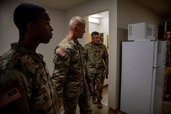 Command Sgt. Maj. Thomas Holland, the senior enlisted advisor for the 18th Airborne Corps, walks through the 525th Military Intelligence Brigade barracks room Tuesday, Aug. 30, 2022, at Fort Bragg. Soldiers in Smoke Bomb Hill barracks are in the process of moving into other barracks on the installation.