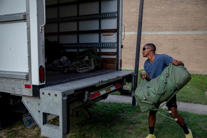 Pfc. Fredrick Swingle, a soldier with the 505th Parachute Infantry Regiment, 3rd Brigade Combat Team, 82nd Airborne Division, loads a moving truck with bags during the Smoke Bomb Hill barracks move out Wednesday, Aug. 28, 2022, at Fort Bragg.