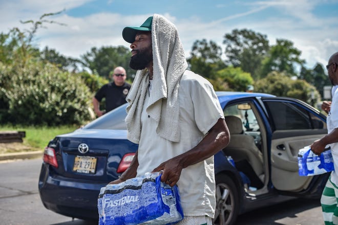 Incarcerated persons help distribute water amidst Jackson's water crisis at the Salvation Army facility in Jackson, Miss., Friday, Sept. 2, 2022.