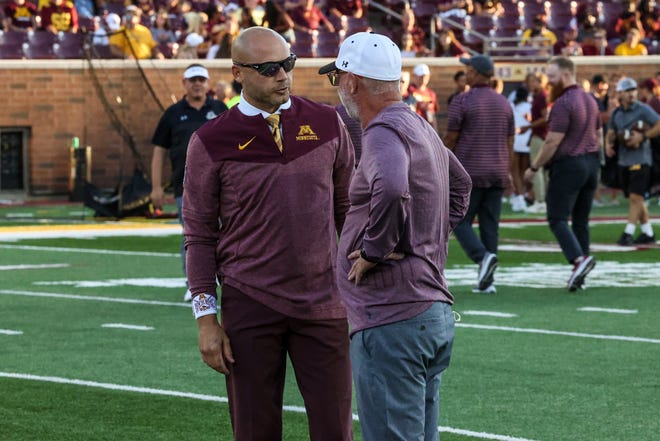Minnesota football coach PJ Fleck, left, and New Mexico State coach Jerry Kill, speak before Thursday's football game in Minnesota.