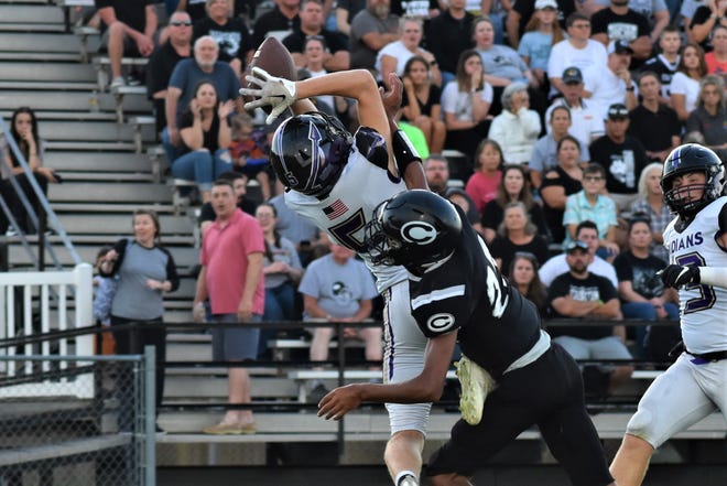 Hallsville receiver Isaac Stinson (5) highlights a 44-yard reception over a Centralia defender as the crowd watches during the Panthers' 26-20 victory over Hallsville on September 2, 2022.