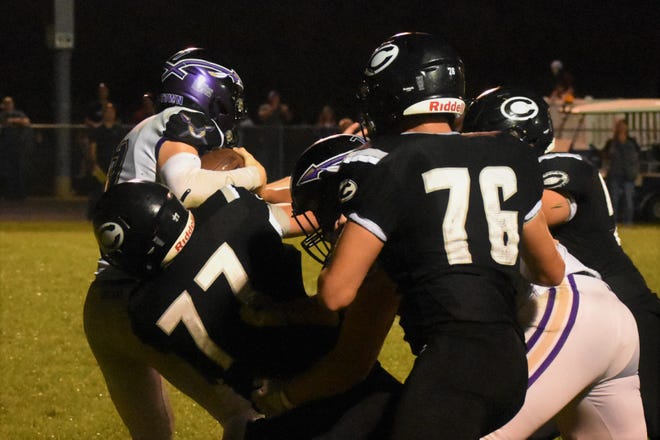 Hallsville quarterback Colton Nichols is sucked into a swarm of Centralia defenders during the Panthers' 26-20 victory over Hallsville on September 2, 2022.