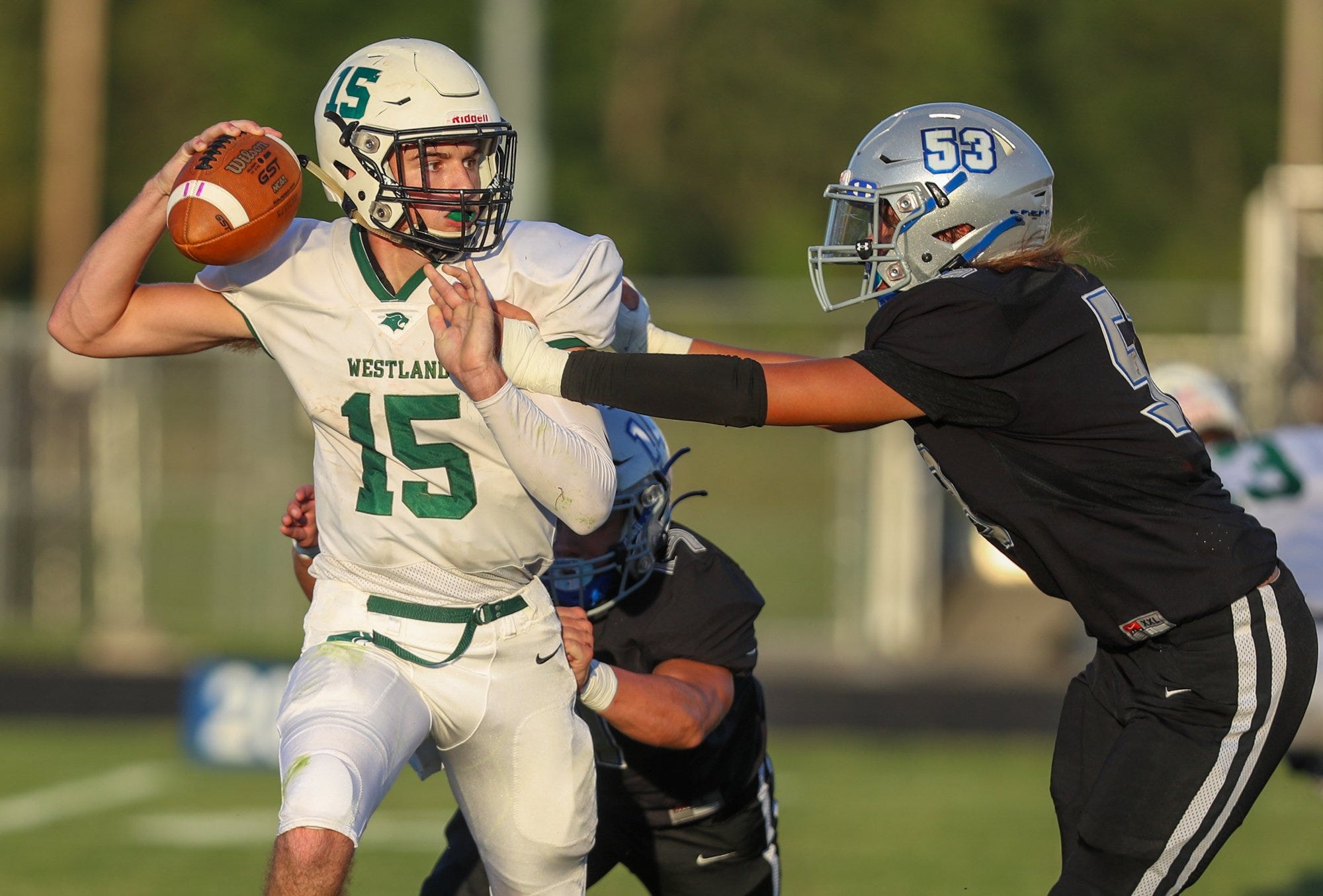 Central Crossing's Kyle Kuskamp gets a hand on Westland quarterback Levi Estep on Sept. 2.