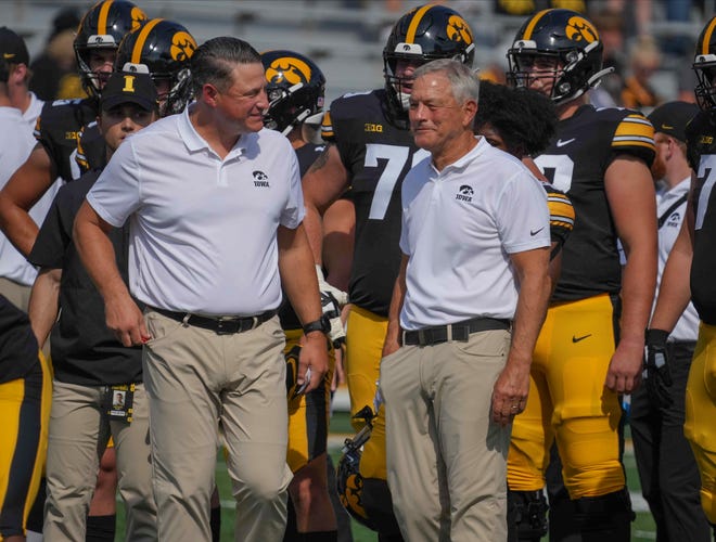 Iowa offensive coordinator Brian Ferentz, left, and head coach Kirk Ferentz were dismissed "without prejudice" by plaintiffs' attorneys in a federal racial discrimination lawsuit on Monday. That means they could be re-added a later time but likely points toward a settlement in the works.