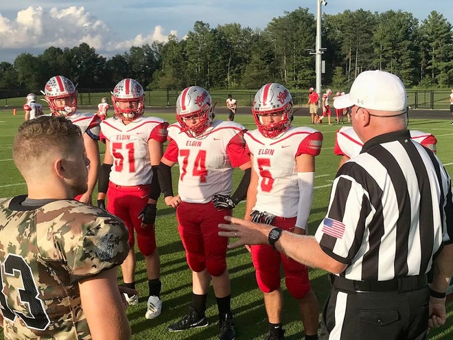 Elgin's captains meet the Mount Gilead captains for the coin toss before the start of the Week 3 game at Mount Gilead. The Comets will host Ridgedale Friday night in a Northwest Central Conference football game.