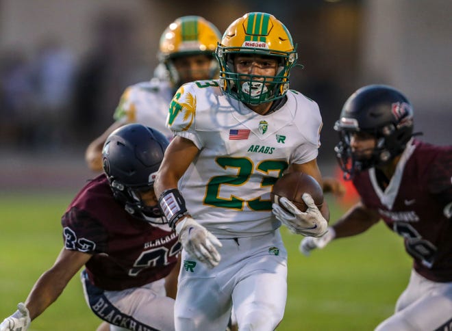 Coachella Valley's Aaron Ramirez (23) carries the ball during the first quarter of their game at La Quinta High School in La Quinta, Calif., Friday, Sept. 2, 2022. 