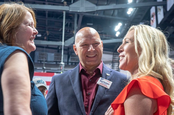 Rebbeca and Doug Mastriano, PA gubernatorial candidate, in center, with Congresswoman Marjorie Taylor Greene, on right, at the Save America rally at the Mohegan Sun Casey Arena in Wilkes-Barre, P.A. on Saturday, Sept. 3, 2022.
