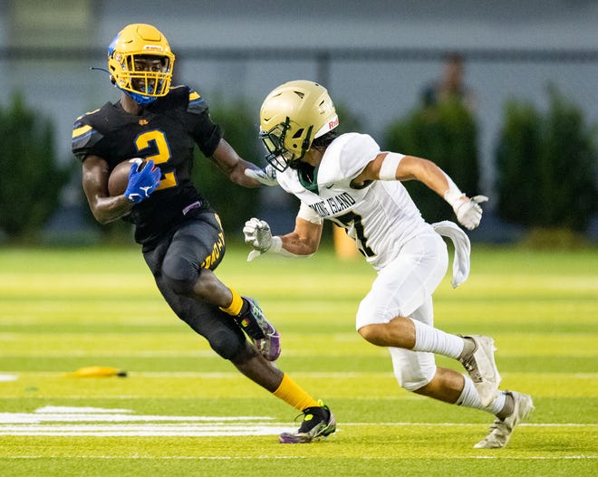 Rickards wide receiver Rico Watkins (2) pushes off a defender as he sprints down the field. The Rickards Raiders hosted the Fleming Island Golden Eagles at Gene Cox Stadium on Friday, Sept. 2, 2022. 