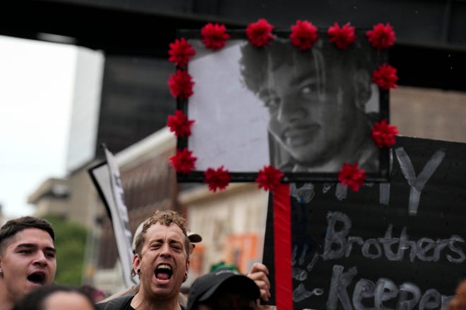 Sep 4, 2022; Columbus, Ohio, USA; A picture of Donovan Lewis is seen as protestors chant while marching through downtown Columbus during a Donovan Lewis protest outside of The Ohio Statehouse. Mandatory Credit: Joseph Scheller-The Columbus Dispatch