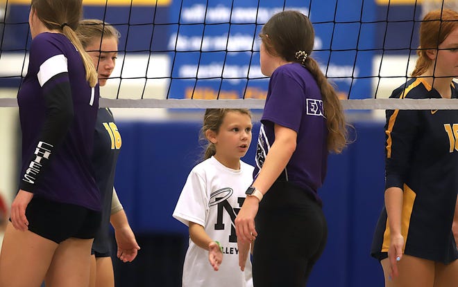 Notre Dame’s smallest helper is Grace Reid goes through the postgame greeting line with the team after the game against Keokuk Saturday at the Notre Dame Nikes Invitational in Burlington.