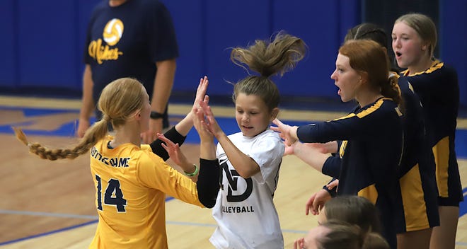 Notre Dame’s Grace Reid high fives Ava Parkins (14) who makes a switch during the game against Wapello Saturday at the Notre Dame Nikes Invitational in Burlington.