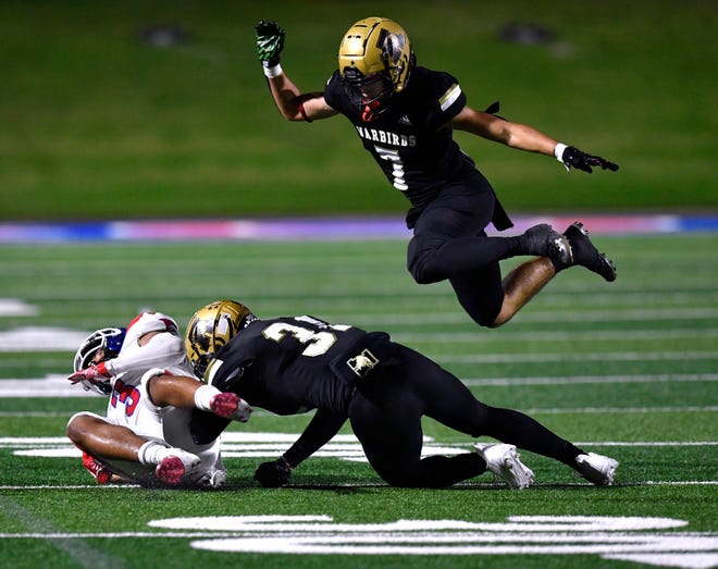 Eagles defensive back Noah Hatcher soars over the tackle between Cooper wide receiver D'Andre Ralston and Abilene High linebacker Kenneth Johnson during Friday's crosstown showdown at Shotwell Stadium Sept. 2, 2022. Final score was 14-10, Abilene High.