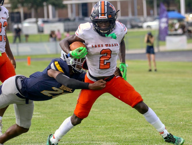 Carlos Mitchell of Lake Wales tries to escape the entrance of Damil Palmer of Ridge Community.