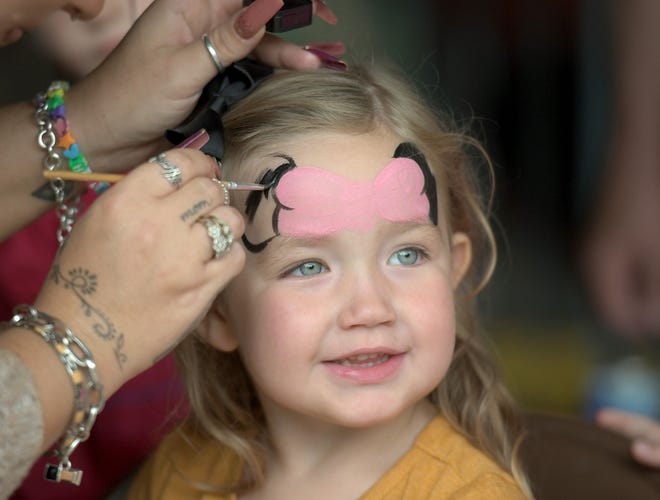 Marynn Townsend, 3 years old, of Shelby, gets her face painted at the Richland Carrousel Park.