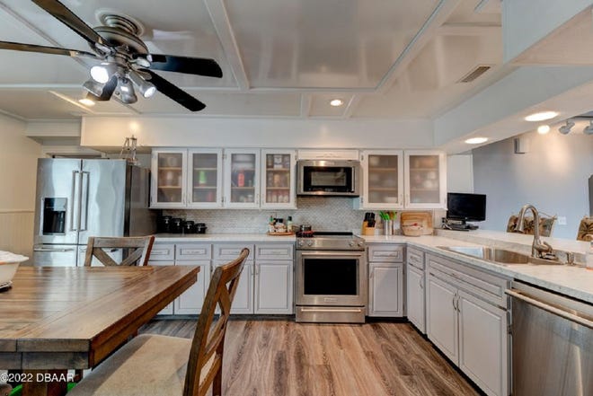 This beautifully updated kitchen features stainless-steel appliances,  modern cabinetry, an eat-in area and tons of pantry space.