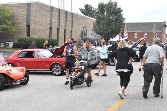 Spectators stroll Fourth Street to view some of the 141 cars in the Orion Fall Festival car show on Sunday, Sept. 4.