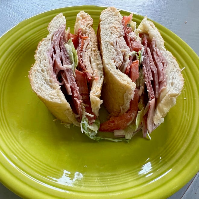Filled with lettuce, tomatoes and Italian meats, this giant sandwich is a yummy way to quickly put together a weeknight meal.