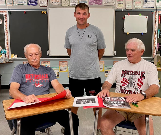 The 2022 season marks 100  years for Meyersdale football. Red Raiders coach Ryan Donaldson (standing) said it is an honor to be a part of a legacy that dates back to the 1920s and includes such greats as Fred DiPasquale (left) and Dennis Stahl (right). On Oct. 7, Homecoming 2022, the Sideline Club, Meyersdale Area School District and student council is inviting Red Raiders and their fans to a special open house at the high school from 4:30-5:30 p.m. Prior to the game against the Windber Ramblers, the football boosters plan to recognize all Red Raiders football players in attendance. Organizers are inviting any former player to attend the celebratory game. Those in attendance will be brought onto the football field prior to the game, at 6 p.m., to be recognized.