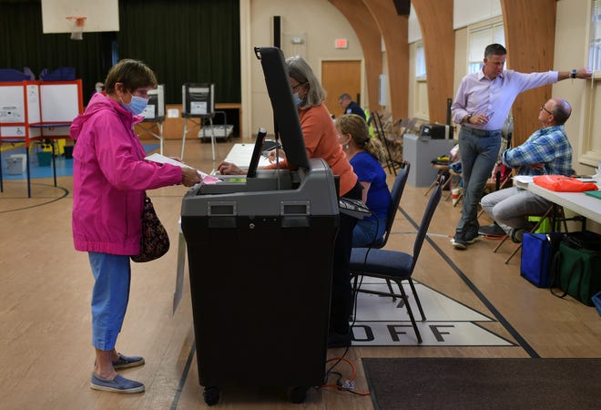 Phyllis McGill casts her vote Tuesday at the Salem Covenant Church polling place.
