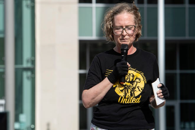 Jen Hampton, Asheville Food and Beverage United lead organizer, speaks outside the Buncombe County Courthouse September 6, 2022.