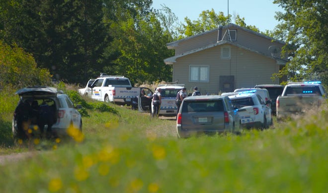 In this image taken from video, Canadian law enforcement personnel surrounded a residence on the James Smith Cree First Nation reservation in Saskatchewan, Canada, Tuesday, Sept. 6, 2022, as they search for a suspect in a series of stabbings. (AP Photo/Robert Bumsted) ORG XMIT: CNRB201
