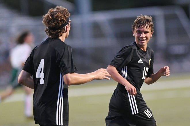 Quaker Valley's Cameron Diggins (10) looks back at teammate Bennett Haas (4) after scoring a goal seconds before the half during Tuesday night's game against Riverside at Quaker Valley High School.