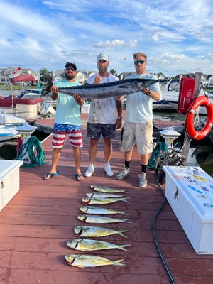 Hunter, Curtis and Cody Presnell at the Harbor Island Marina their catch of the day --  a 55-pound wahoo and mahi.
