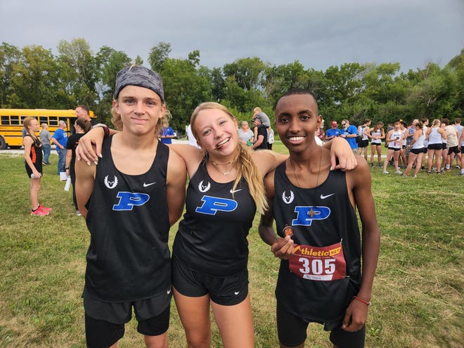 Perry runners Thad Stewart (9th), Julie Maylum (8th) and Yonas Andemichael (4th) pose for a photo after medaling on Thursday, Sept. 1, 2022, in Madrid.