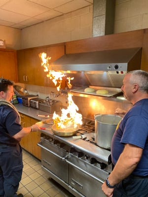 Worcester Firefighters Rob Binette, left, and Brendan Coyne prepare for the Paragus Firehouse Cook Off, to be held Sept. 29, during a cooking session Wednesday at the Franklin Street station.