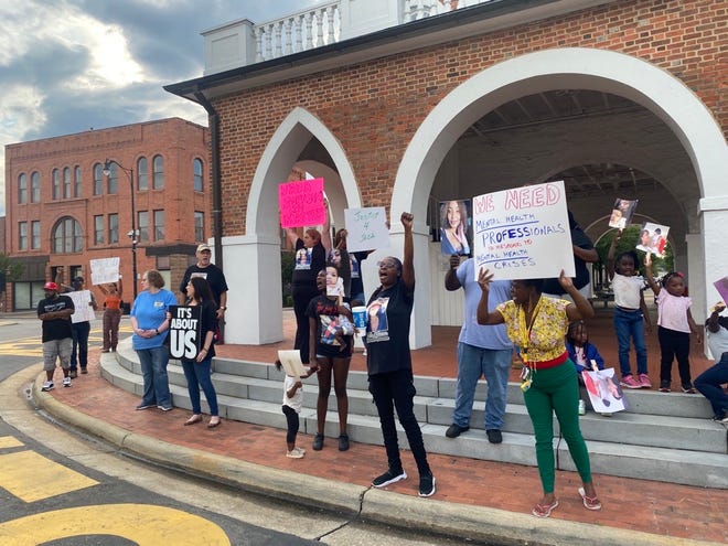 Protesters at the Market House chant and hold signs to call for police reform in the wake of Jada Johnson's death. Johnson, 22, was killed by a Fayetteville police officer July 1 during what her grandparents have called a "mental health crisis."