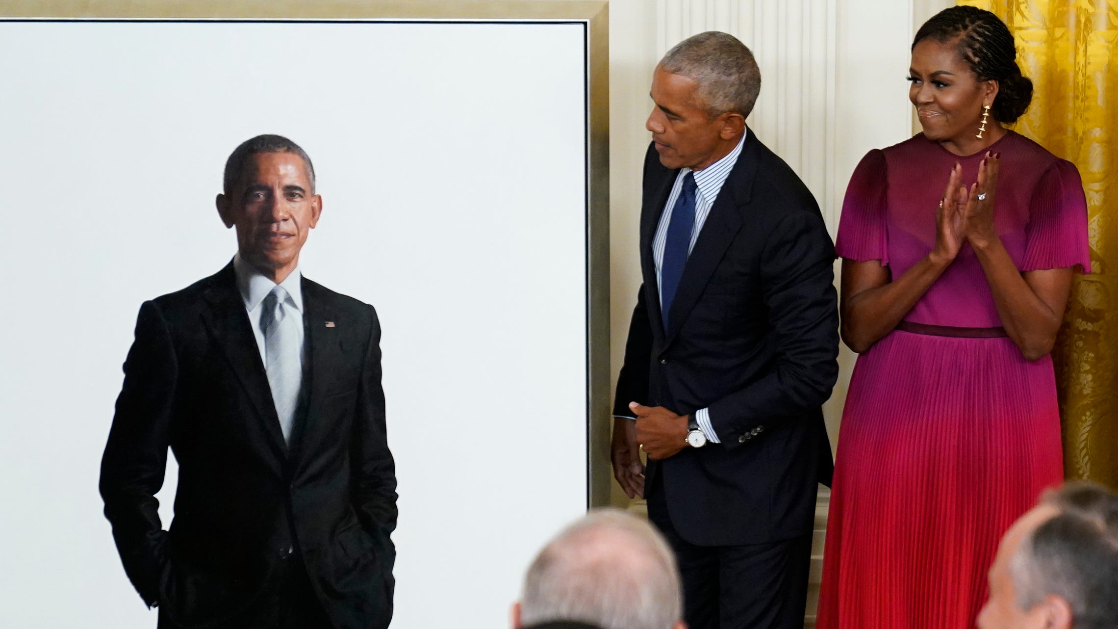 Obamas return to the White House for unveiling of official portraits