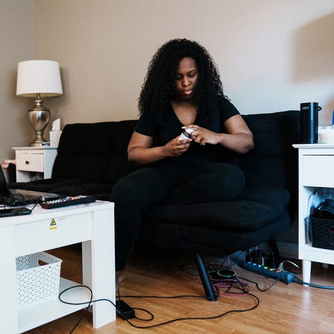 Cynthia Adinig, 37, opens a bottle of antihistamin