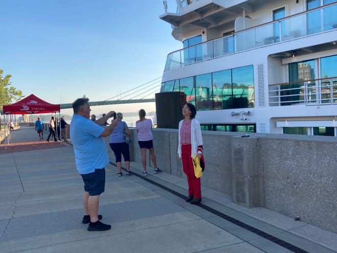 Jerry Johnson takes a photo of Christine Williamson Thursday, Sept. 8, 2022, in front of the Viking Mississippi along Burlington's riverfront.