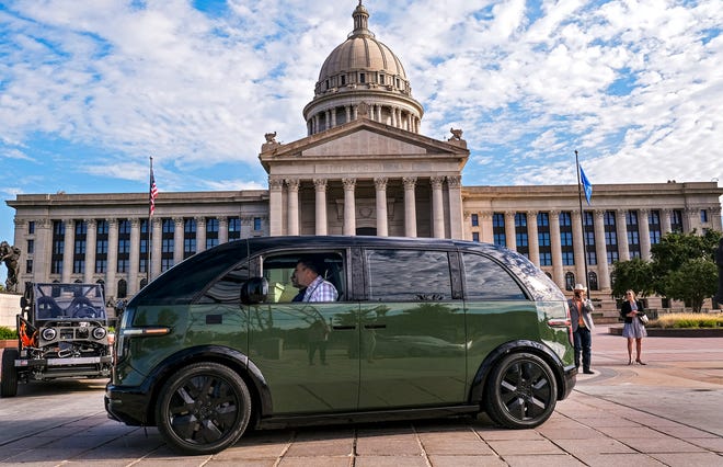 Gov. Kevin Stitt gets behind the wheel for a test drive of a Canoo 7 passenger van on display Wednesday, Aug. 10, 2022, at the state Capitol in Oklahoma City.