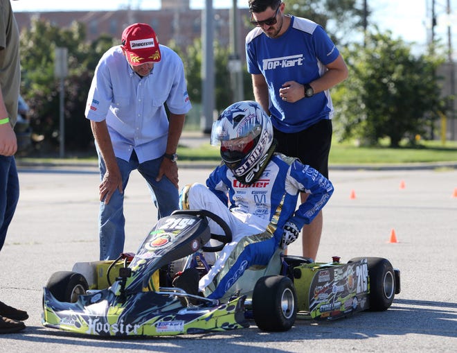Nick Molchan, a sophomore at Hobart High School, gets into his high school’s EV kart during testing in the parking lot of Purdue Polytechnic High School in South Bend. Purdue Polytech teamed with Purdue Motor Sports to have a “Test and Tune” session in South Bend on Thursday, Sept. 8, 2022, for high school teams that are part of the EV Grand Prix kart program.