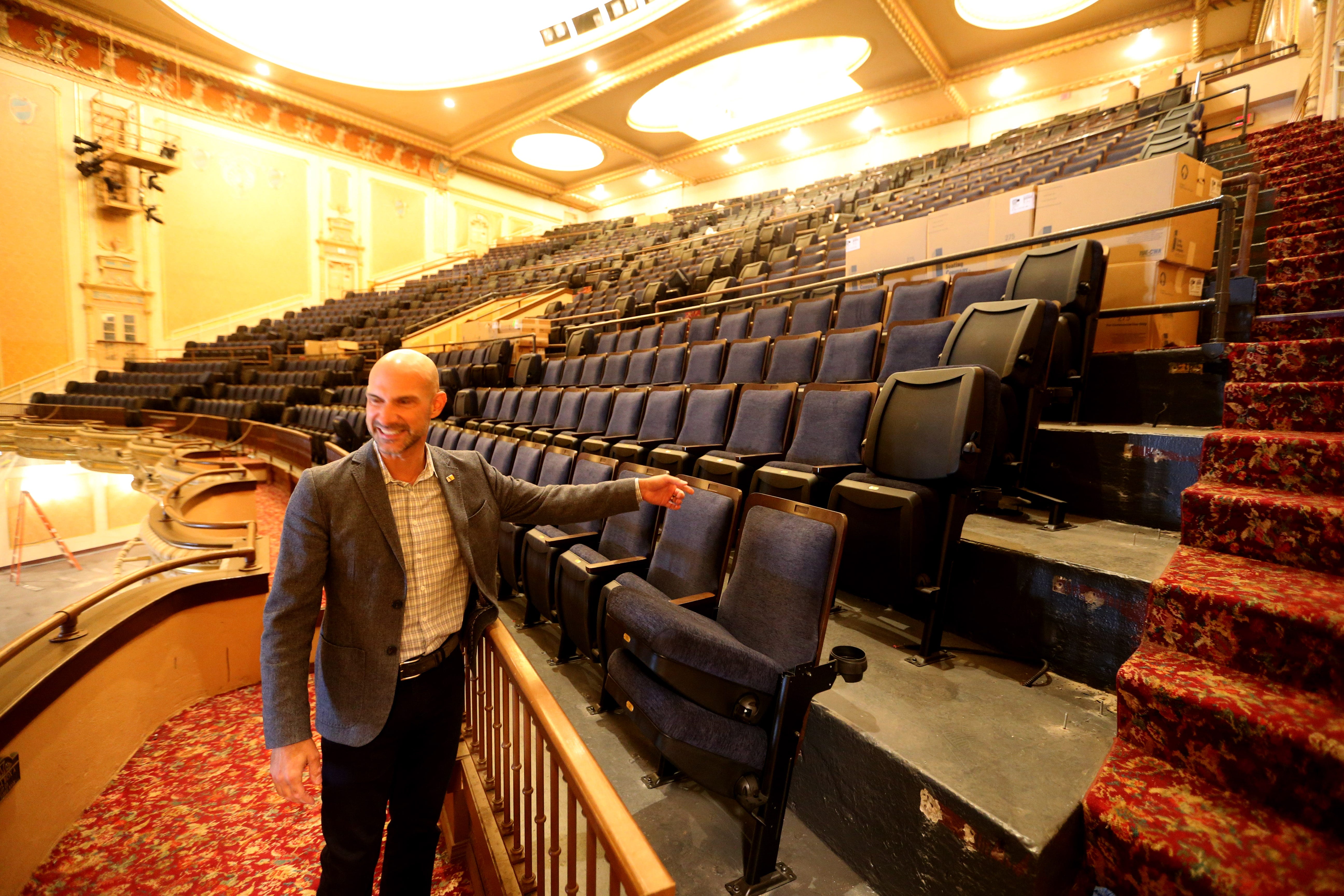 Aaron Perri, executive director of South Bend Venues, Parks & Arts, shows some of the newly installed seating in the balcony of the Morris Performing Arts Center. The Morris is undergoing a renovation of more than $8 million in time for the 100th anniversary of the venue.