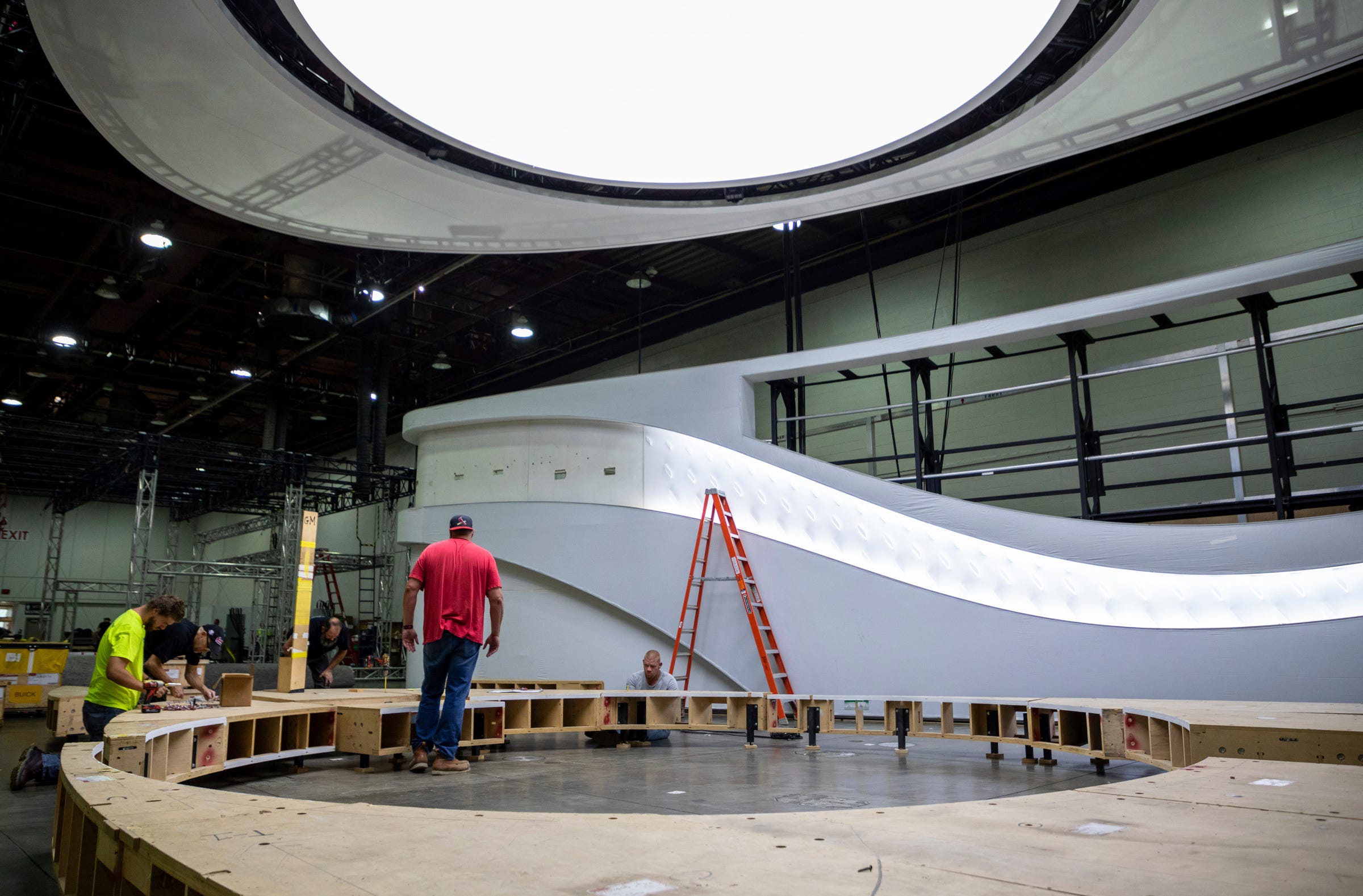 Employees work to get the North American International Auto Show up and running inside the Huntington Place convention center in Detroit on Wednesday, Sept. 7, 2022.