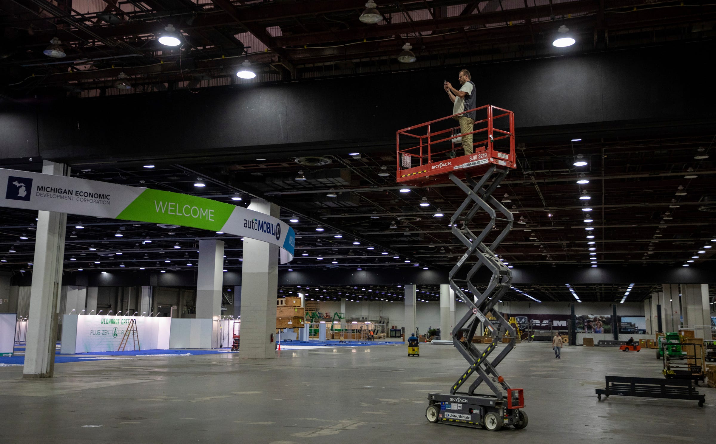 Willie Biggs, 58, retired carpenter, takes video of the preparations for the North American International Auto Show inside the Huntington Place convention center in Detroit on Wednesday, Sept. 7, 2022.