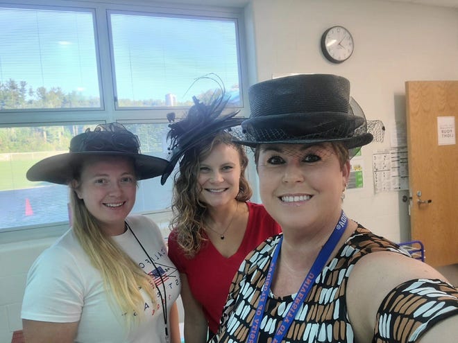 From left, Danielle Rasmus, Leighan Wells and Libby Nickoli wear hats to honor Queen Elizabeth II after news of her passing.