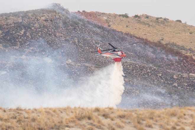 Crews fight a grass fire on Thursday, September 8, 2022, north of Fort Collins, Colo.