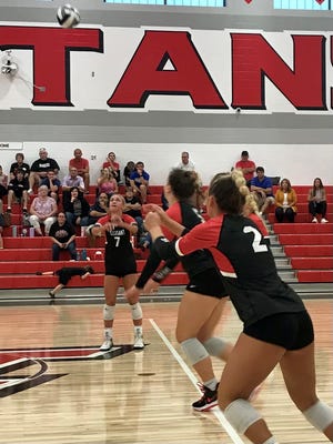 Pleasant's Emerson Williams sets the ball to Kenna Ambrose during a match against Ontario that opened up the new gym at Pleasant on Thursday.