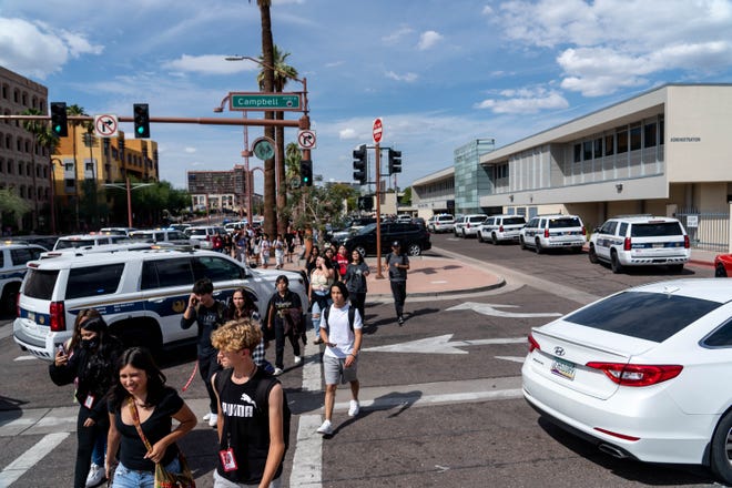 Students walk along Central Avenue towards Steele Indian School Park after being evacuated from Central High School following a campus lockdown in Phoenix on Sept. 9, 2022.