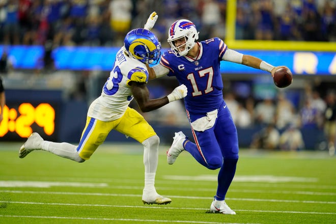 Buffalo Bills quarterback Josh Allen (17) stiff-arms Los Angeles Rams safety Nick Scott during the second half of an NFL football game Thursday, Sept. 8, 2022, in Inglewood, Calif.