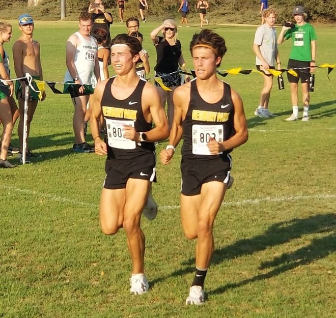 Leo Young, left, and Lex Young head to the finish line during the first Marmonte League meet of the season at Peppertree Playfield in Thousand Oaks. Lex was first in 14:48.40; Leo was next in 14:48.42.