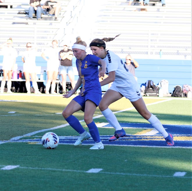 Philo's Sara Searls hits the ball upfield against River View's Paige Stone in Thursday's MVL girls soccer match. River View won 2-0.