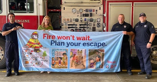 Local State Farm agent Sarah Wickerham, second from left, recently donated a Fire Prevention Week kit to the Zanesville Fire Department. The kit includes activities and information for children and adults with age appropriate messages about home fire safety and prevention. Fire Prevention Week is Oct. 9 to 15.